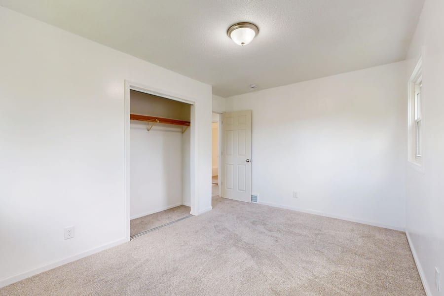 Newly fitted pale carpet in a bright bedroom