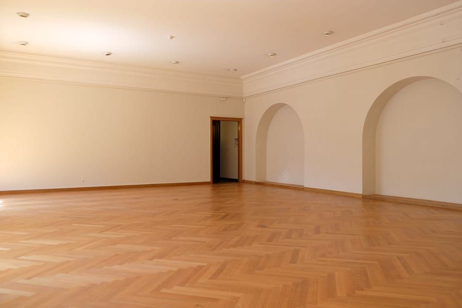 Oak herringbone parquet floor in a large, light room